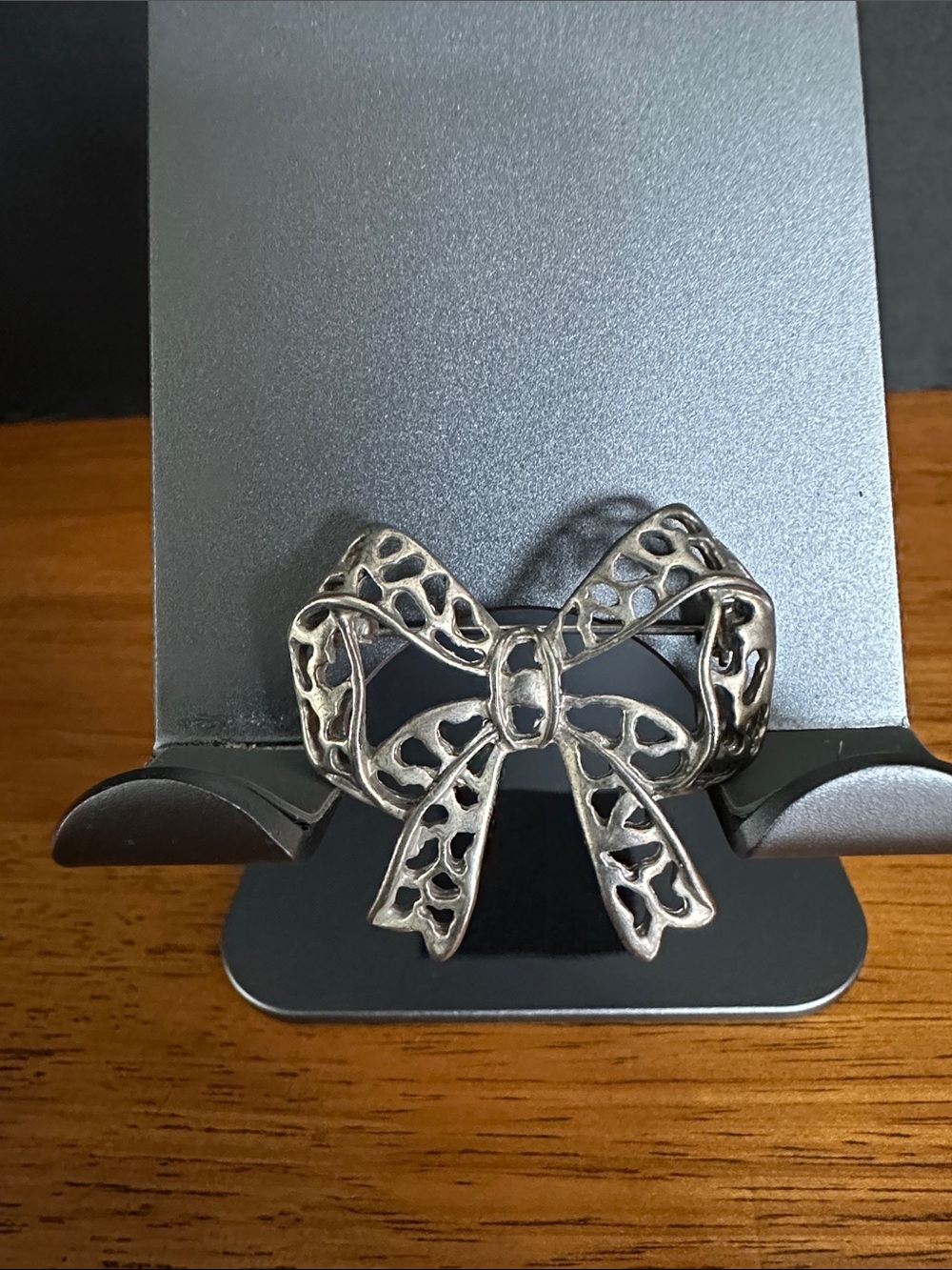 Silvertone vintage brooch in the shape of a bow.